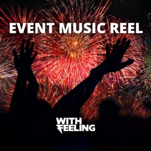 Fireworks bursting over a crowd with raised hands at a live event