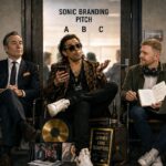 Three sonic branding agency archetypes waiting outside a pitch room: a corporate executive with binders of data, a starstruck music-industry connector in a leopard-print jacket, and an independent creative with headphones and a notebook of ideas
